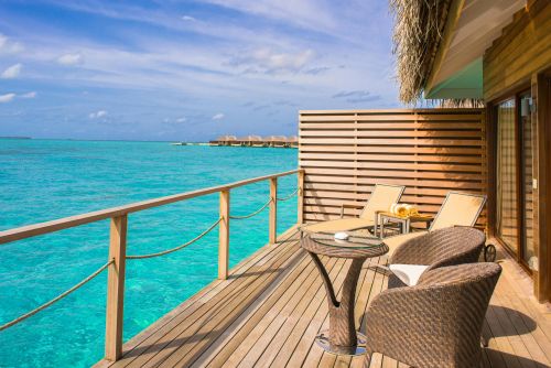 Peaceful overwater bungalow with ocean view, perfect for a tropical getaway.