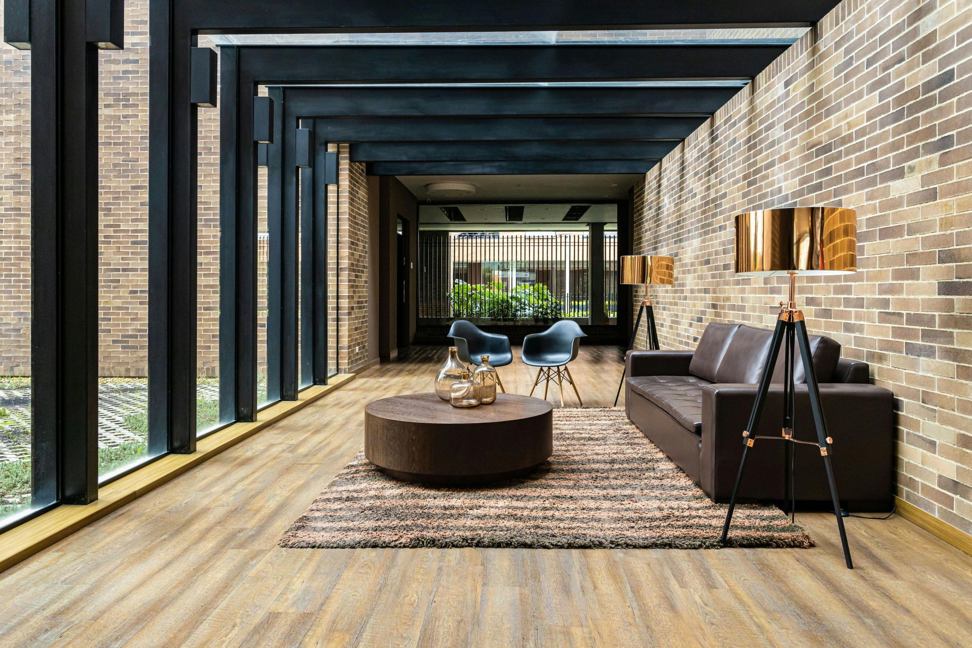 Contemporary home interior with leather couch and wooden floor in Bogota.