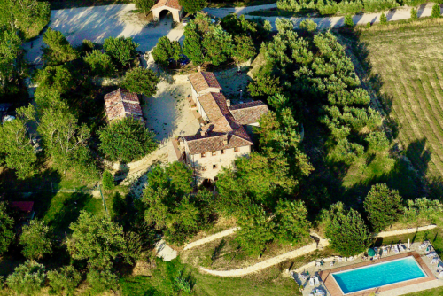 Stunning aerial view of a luxury villa with a swimming pool in the Maldives over turquoise waters.